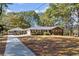 Brick ranch home with carport and mature landscaping at 2639 Odum St, Snellville, GA 30078