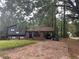 Brick ranch house with a carport and mature trees at 3230 Vanderbilt Nw Ln, Atlanta, GA 30318