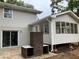 Updated house exterior with sunroom addition and brick fire pit at 3666 Elkridge Dr, Decatur, GA 30032