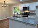 Modern kitchen with island, stainless steel appliances, and hardwood floors at 3666 Elkridge Dr, Decatur, GA 30032