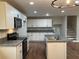 Modern kitchen with island, stainless steel appliances, and hardwood floors at 3666 Elkridge Dr, Decatur, GA 30032
