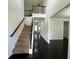 Two-story foyer with dark hardwood floors and iron railing staircase at 2451 Overlook Ave, Lithonia, GA 30058