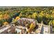 Aerial view of an apartment complex with a pool, surrounded by autumn trees at 2300 Peachford Rd # 1209, Atlanta, GA 30338