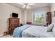 Spacious bedroom with a queen bed, dresser, and ceiling fan at 2300 Peachford Rd # 1209, Atlanta, GA 30338