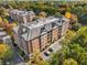 Aerial view of two brick apartment buildings surrounded by autumn trees at 2300 Peachford Rd # 1209, Atlanta, GA 30338