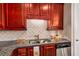 Kitchen features granite countertops, double sink, and wood cabinets at 2300 Peachford Rd # 1209, Atlanta, GA 30338