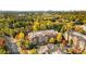 Aerial view of an apartment building nestled in a wooded area, showcasing fall colors at 2300 Peachford Rd # 1209, Atlanta, GA 30338