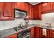 Kitchen boasts granite countertops and rich wood cabinets at 2300 Peachford Rd # 1209, Atlanta, GA 30338