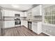 Modern kitchen with white cabinets and granite countertops at 3276 Marlanta Dr, Marietta, GA 30062