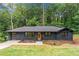 Modern dark-painted ranch house with a new garage at 1300 Aniwaka Sw Ave, Atlanta, GA 30311