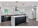 Modern kitchen with large island, white quartz countertops, and dark cabinets at 1300 Aniwaka Sw Ave, Atlanta, GA 30311