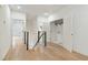 Upstairs hallway with light wood floors and modern railing at 1695 North Nw Ave, Atlanta, GA 30318