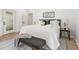 Main bedroom with plush bed, bench, and wood floors at 1695 North Nw Ave, Atlanta, GA 30318