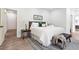 Main bedroom with plush bed, bench, and wood floors at 1695 North Nw Ave, Atlanta, GA 30318