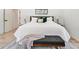 Main bedroom with plush bed, bench, and wood floors at 1695 North Nw Ave, Atlanta, GA 30318
