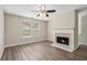 Living room with fireplace, ceiling fan, and wood-look flooring at 6943 Fairway Trl, Austell, GA 30168
