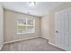 Well-lit bedroom featuring neutral walls and carpet at 6943 Fairway Trl, Austell, GA 30168