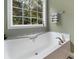 Relaxing bathroom with soaking tub, shower, and updated fixtures at 110 Lava Ct, Carrollton, GA 30116