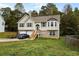 Two-story house with a brick and beige exterior, two-car garage, and a landscaped yard at 110 Lava Ct, Carrollton, GA 30116