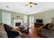 Living room with hardwood floors, a fireplace, and two brown sofas at 110 Lava Ct, Carrollton, GA 30116