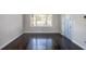 Spacious living room with dark hardwood floors and large window at 3060 Washington Rd, Atlanta, GA 30344