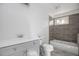 Clean bathroom with gray tile, a bathtub, and a vanity with a white countertop at 3060 Washington Rd, Atlanta, GA 30344