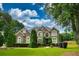 Two-story brick home with lush landscaping at 225 Asante Dr, Ellenwood, GA 30294