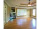 Main bedroom with hardwood floors, tray ceiling, and fireplace at 225 Asante Dr, Ellenwood, GA 30294