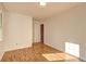 Well-lit bedroom featuring hardwood floors and an adjacent door at 125 Sagamore Ct, Fayetteville, GA 30214