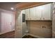 Laundry room with built-in cabinets and vinyl flooring at 1328 White Oak Se St, Conyers, GA 30013