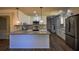 Modern kitchen with island, granite countertops, and stainless steel appliances at 1328 White Oak Se St, Conyers, GA 30013