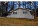 Side view of a charming brick ranch home with mature trees at 1328 White Oak Se St, Conyers, GA 30013