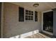 Front entry with black door, stone flooring and updated shutters at 1328 White Oak Se St, Conyers, GA 30013