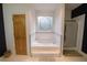 Bathroom with a large bathtub, shower, and updated vanity at 3598 Brock Rd, Duluth, GA 30096