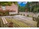 Deck with wooden benches, landscaping, and a potted plant at 3598 Brock Rd, Duluth, GA 30096