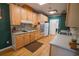 Kitchen features light wood cabinets, double oven, and hardwood floors at 3598 Brock Rd, Duluth, GA 30096