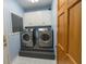 Laundry room includes washer, dryer, and upper cabinets at 3598 Brock Rd, Duluth, GA 30096