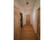 Light-filled hallway with wood floors and access to other rooms at 3598 Brock Rd, Duluth, GA 30096