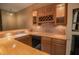 Basement bar with wood cabinets and tile backsplash at 3598 Brock Rd, Duluth, GA 30096