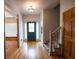 Bright entryway with hardwood floors, stairs, and green door at 3598 Brock Rd, Duluth, GA 30096