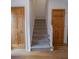 Elegant staircase with carpeted steps and wooden handrail at 3598 Brock Rd, Duluth, GA 30096