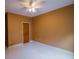 Empty bedroom with neutral walls, ceiling fan, and wood door at 3598 Brock Rd, Duluth, GA 30096