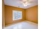 Simple bedroom with neutral walls, ceiling fan, and a window at 3598 Brock Rd, Duluth, GA 30096