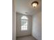 Small bedroom with an arched window and carpeted floor at 3598 Brock Rd, Duluth, GA 30096