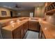 L-shaped basement bar with wood cabinets and countertop at 3598 Brock Rd, Duluth, GA 30096