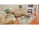 Living room with a fireplace, hardwood floors, and neutral-toned furniture at 176 Spring Walk Way, Lawrenceville, GA 30046