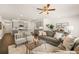 Spacious living room with gray sectional sofa and hardwood floors at 2718 Honey Locust Ct, Loganville, GA 30052