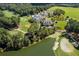 Aerial view of a clubhouse near a golf course and lake at 6202 Talmadge Nw Way, Acworth, GA 30101