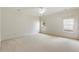 Bright bedroom with neutral walls and carpet, two windows at 6202 Talmadge Nw Way, Acworth, GA 30101