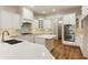 Modern kitchen with white cabinets, quartz countertops and island at 6202 Talmadge Nw Way, Acworth, GA 30101